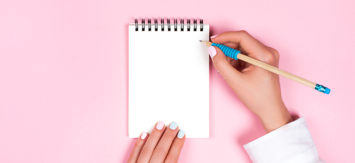 Photo of two hands using a notepad and pencil