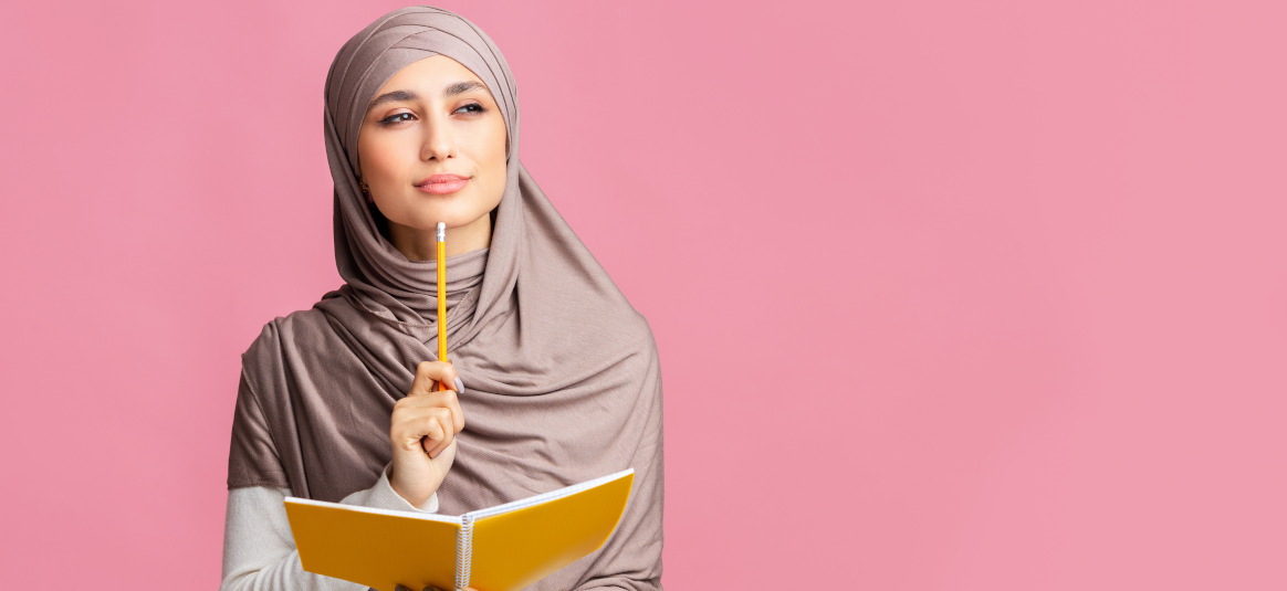 Photo of a contemplative woman with yellow pencil and notebook