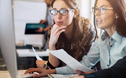 Two women working at a computer