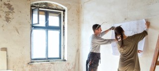 Carpenter in his workshop and using a plumb line