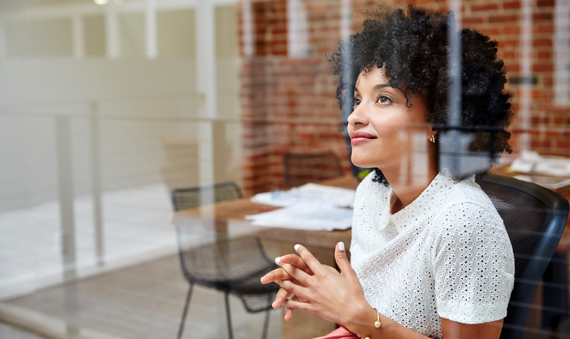 Woman looking through office glass