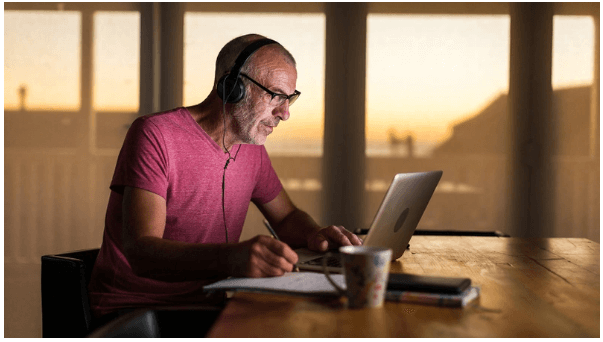 photo of man working on laptop computer