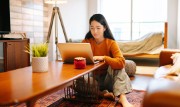 Image of a woman using Video Banking in a cafe