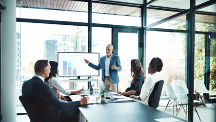 Photo of several office working in a board room